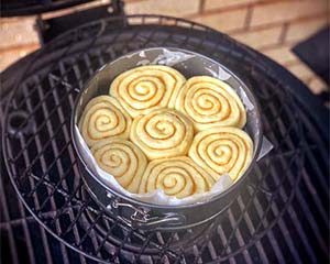 Image of Place cinnamon rolls in a greased 9x9 inch baking pan or round 9 inch cake pan. Cover with  wrap and a warm towel and let rise again for 30-45 minutes.