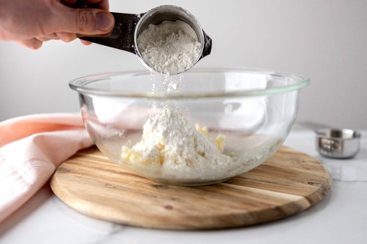 Image of Next, slowly add your flour and mix until a dough...