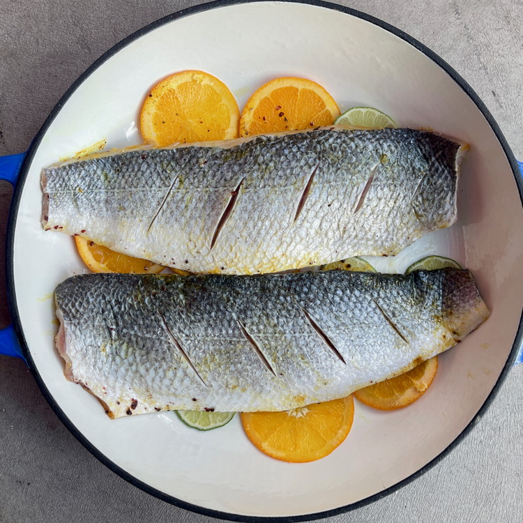 Image of Season both sides with fine sea salt to taste and place them on top of the citrus slices.