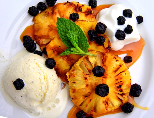 Image of Grilled Pineapple with Vanilla Bean Ice Cream, Dried Blueberries and Caramel Sauce