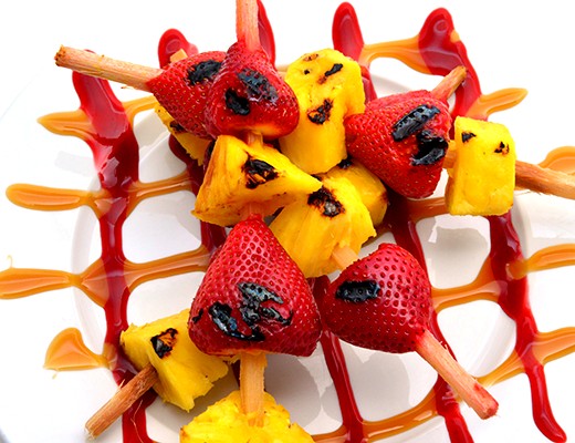 Image of Grilled Sugar Cane Skewered Pineapple and Strawberries with Melissa's Dessert Sauces