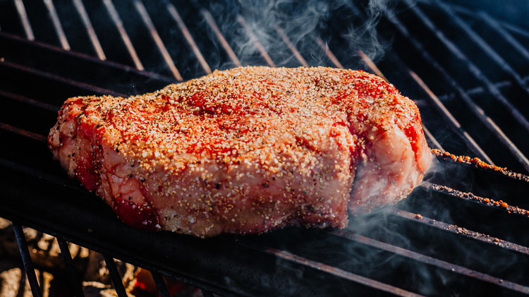 Image of Lay ribeye on the grill over direct heat to begin searing.