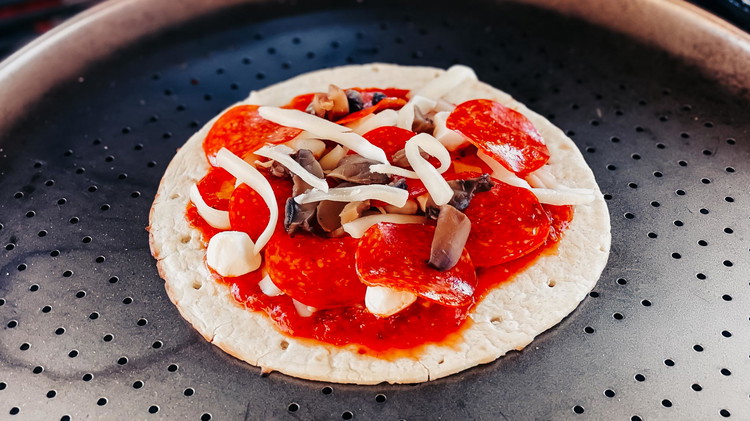 Image of Put pizza sauce on each tortilla round. Top each pizza with mozzarella cheese, sausage, and mini pepperonis (or your favorite pizza toppings).