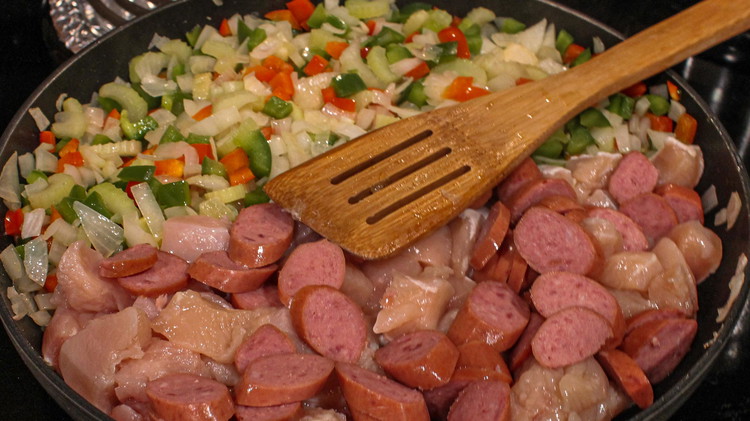 Image of Add the chicken and sausage to the pan and cook for 5-10 minutes until browned and the chicken is no longer pink inside.
