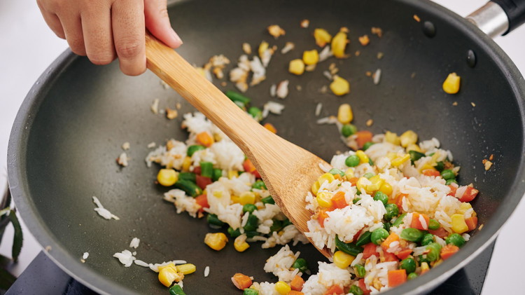 Image of Soft scrambled eggs in the same pan. Add bacon, vegetables, and soy sauce, and mix well.