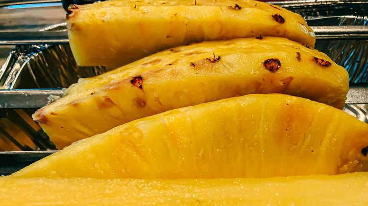 Image of Peel and core a fresh pineapple. Slice into 1/2 inch slices.