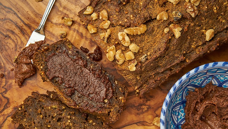 Sliced banana bread with date butter spread.