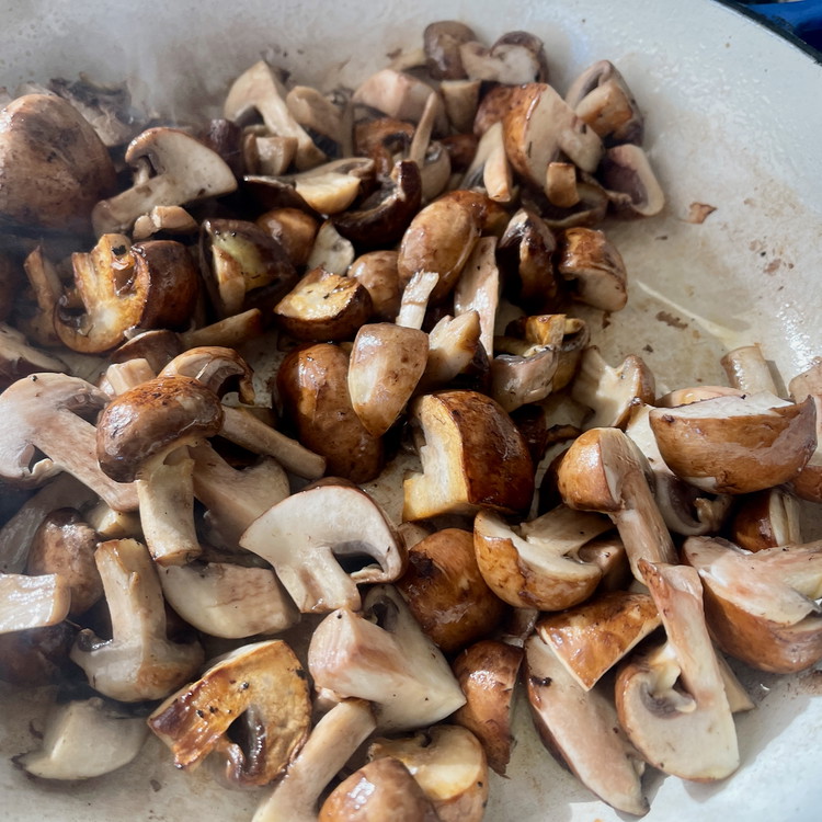 Image of In a heavy bottom skillet large enough to fit the mushrooms in a single layer, heat the olive oil until shimmering and add the mushroom.  Allow the mushrooms to cook over high heat, untouched, until the edges start turning golden brown.  