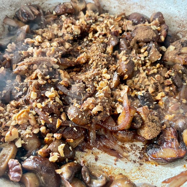 Image of Add the walnuts, salt, Baharat, and black pepper and stir well to combine.