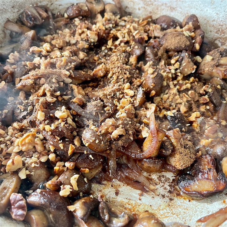 Image of Add the walnuts, salt, Baharat, and black pepper and stir...