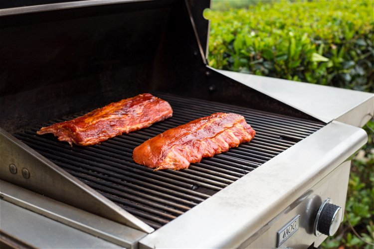 Image of Place the ribs on the grill. If using a gas...