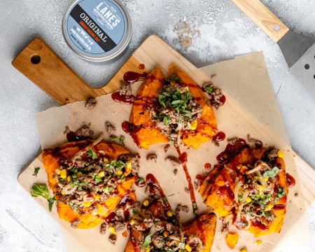 Image of Top smashed sweet potato with mince mixture, parsley, sauce and finishing salt.