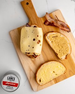 Image of 4. Spread Dijon mustard on the inside of the bread.