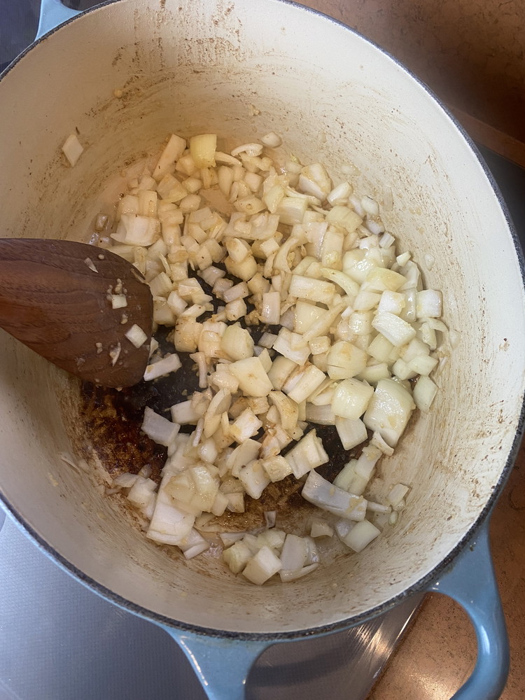 Image of Remove the beef from the pan and set aside. Add a little more oil and sauté garlic and onion until just soft.