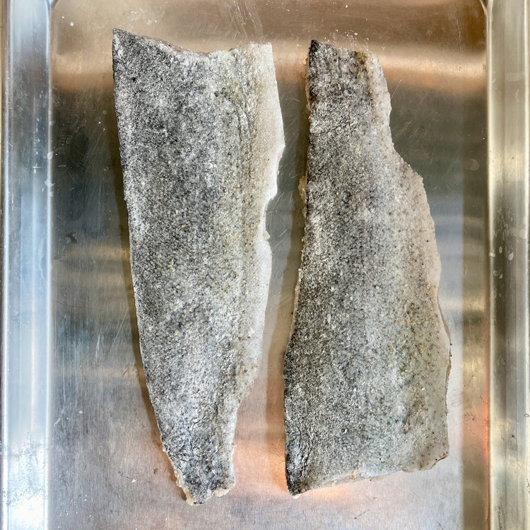 Image of Dust the filet with the flour on the skin side only and knock off the excess.