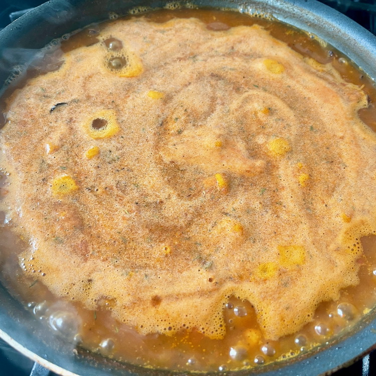 Image of Add the blended tomato and spice liquid, bay leaves, and drained rice and stir to combine.
