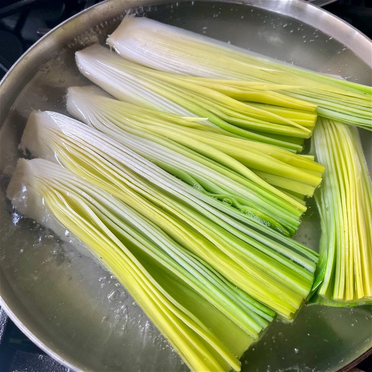 Image of Fill a skillet large enough to fit the leeks in...