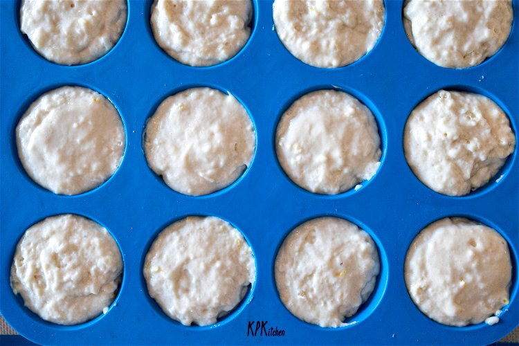 Image of Divide the batter evenly into each muffin cup, filling all...