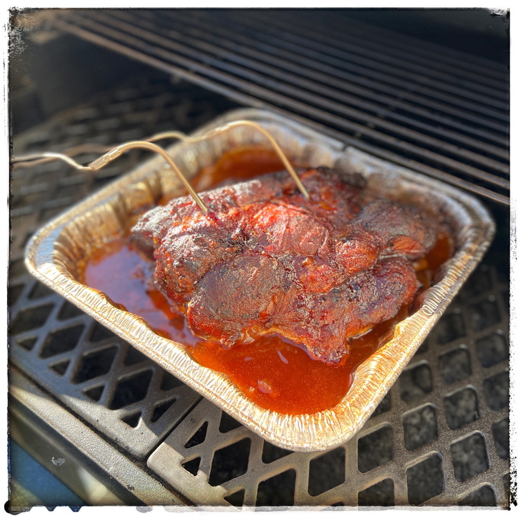 Image of Put the pork into a disposable aluminum roasting pan and add the chicken broth mixture to the pan. 