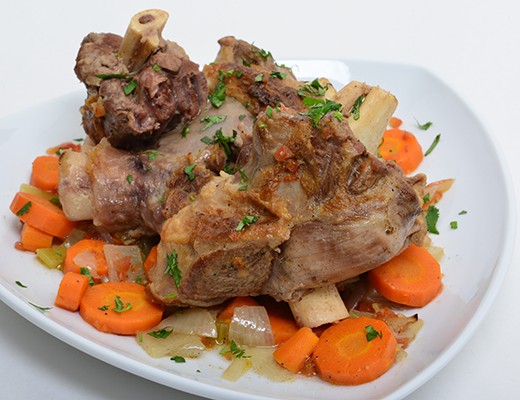 Image of Slow-Roasted Lamb Shanks in a Fresh Tomato Sauce with Carrots and Cumin