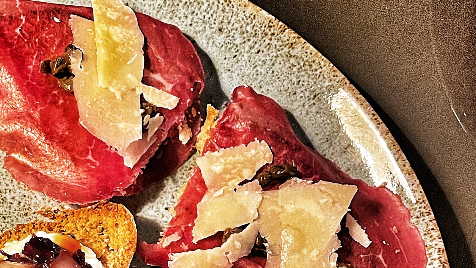 Image of Bresaola crostini with capers, parmigiano reggiano cheese and Tuscan olive oil