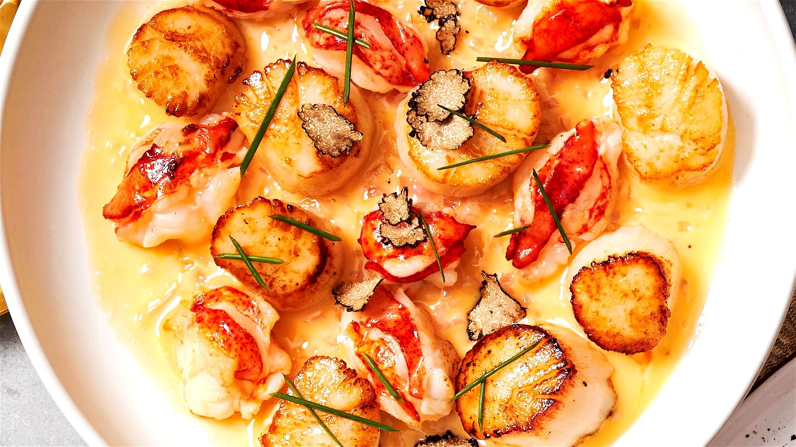 Seared Lobster and Sea Scallops in a Champagne and Truffle Beurre Blanc Sauce-image