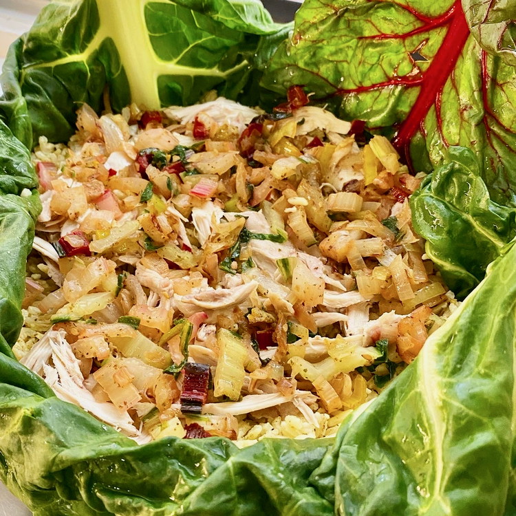 Image of Coat a 9-inch round baking pan with olive oil and use the swiss chard leaves to cover the bottom and sides. Place a third of the rice in the bottom and top with half of the chicken and onion mix....