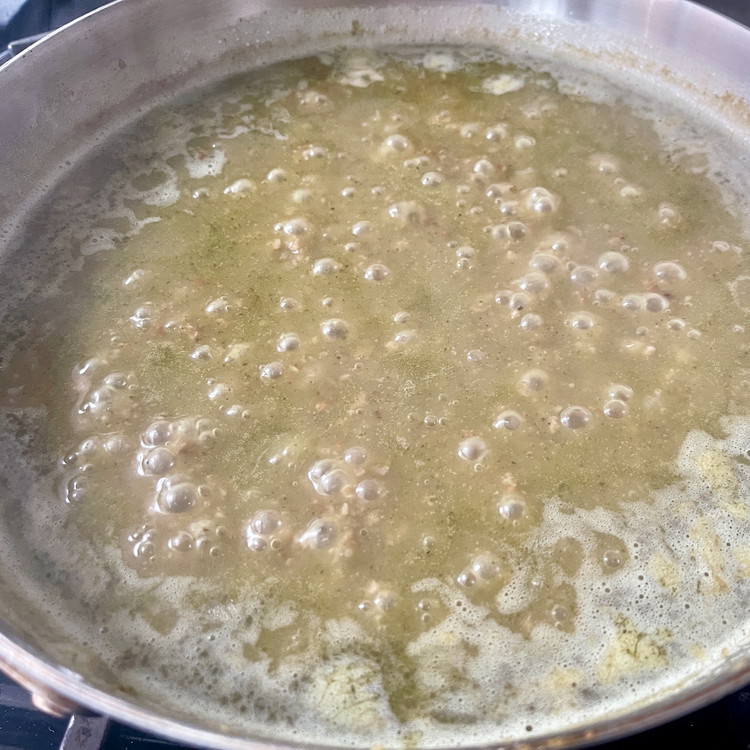 Image of Add the stock (or water), scraping with a silicon spatula to bring up any browned bits, and bring the liquid to simmer for 20 minutes.