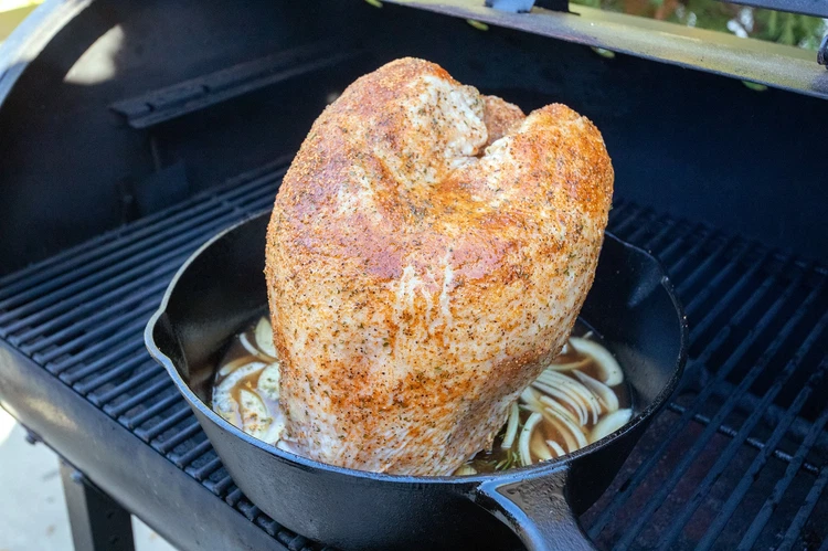 Image of Transfer the turkey to the grill and smoke for 3 hours or until internal temperature reaches 160 F. 