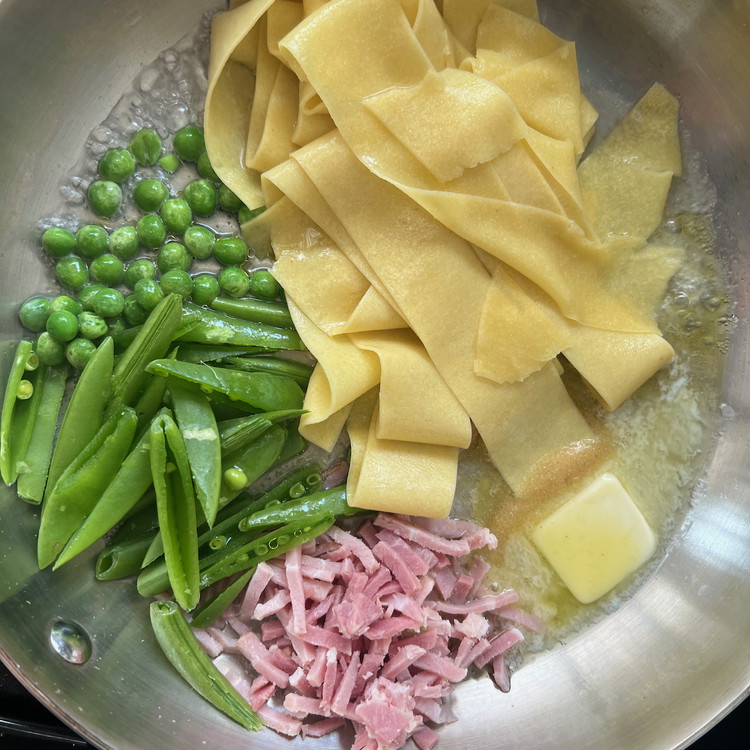Image of In a 10” heavy bottom skillet, add the olive oil, butter, snow peas, ham, granulated onion, and peas.