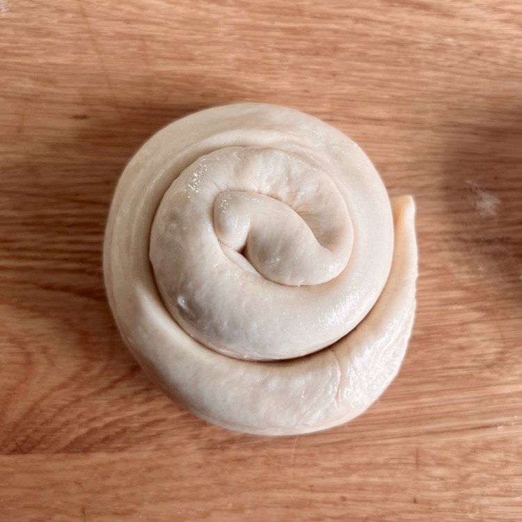 Image of Repeat the rolling out, oiling, and coiling steps to make 8 snails from the balls of dough.