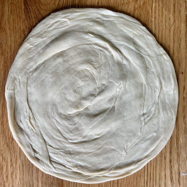 Image of Heat an 8” nonstick pan to medium high heat with a tablespoon of oil and roll each snail into an 8” or 9” disk.