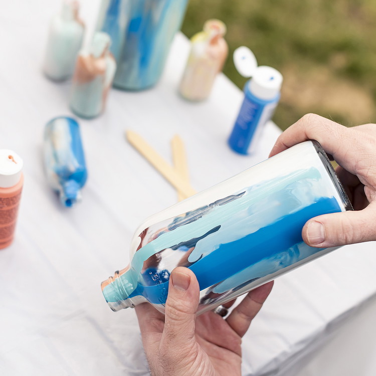 Image of Pour paint into the bottle and rotate it to get desired effect. We went with a marbleized look.