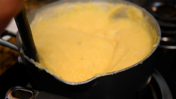 Image of When the grits are cooked, mix in cheese. Season with...