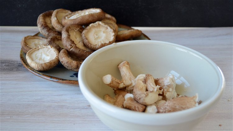 Image of Separate the stems of the shiitake mushrooms from the caps....