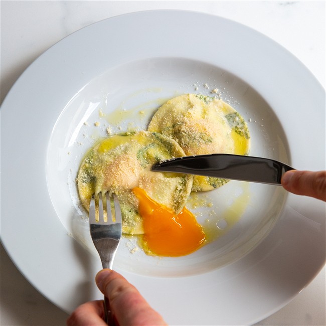 Image of Egg yolk ravioli in a herb laminated pasta
