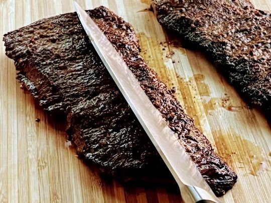Image of Slice the steak (across the grain with the knife at...