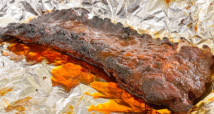 Image of After 2 hours, its time to unwrap the ribs. Be careful when unwrapping the ribs, there will be a significant amount of steam and the ribs will be very tender.