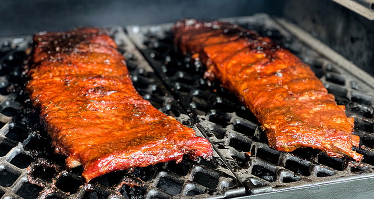 Image of Place the ribs back on the smoker, bone side down and begin to glaze the ribs with The Clevelander, applying every 10 minutes until a sticky glaze is formed. Do this for the last hour of the cook.