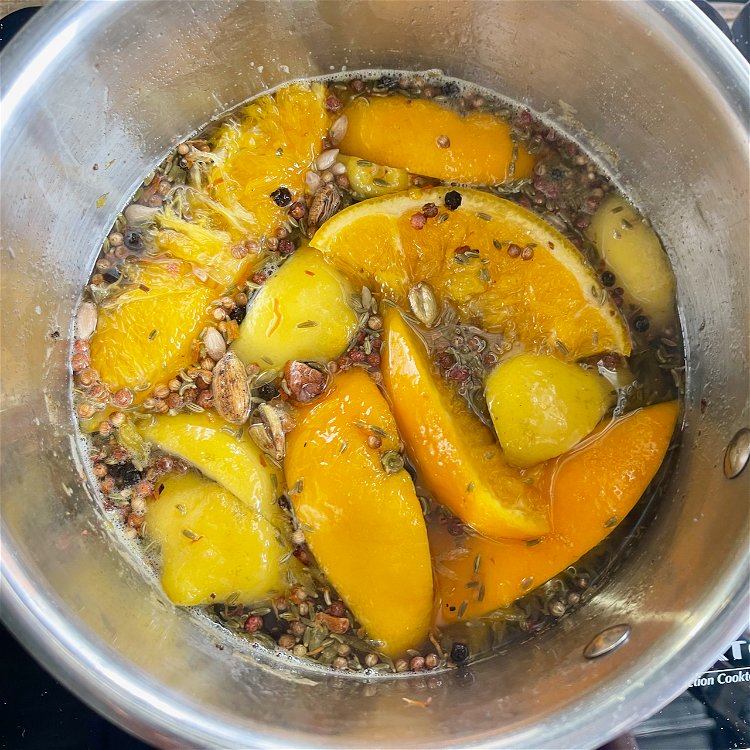 Image of Add the sugar, water and cut citrus. Mix everything well...