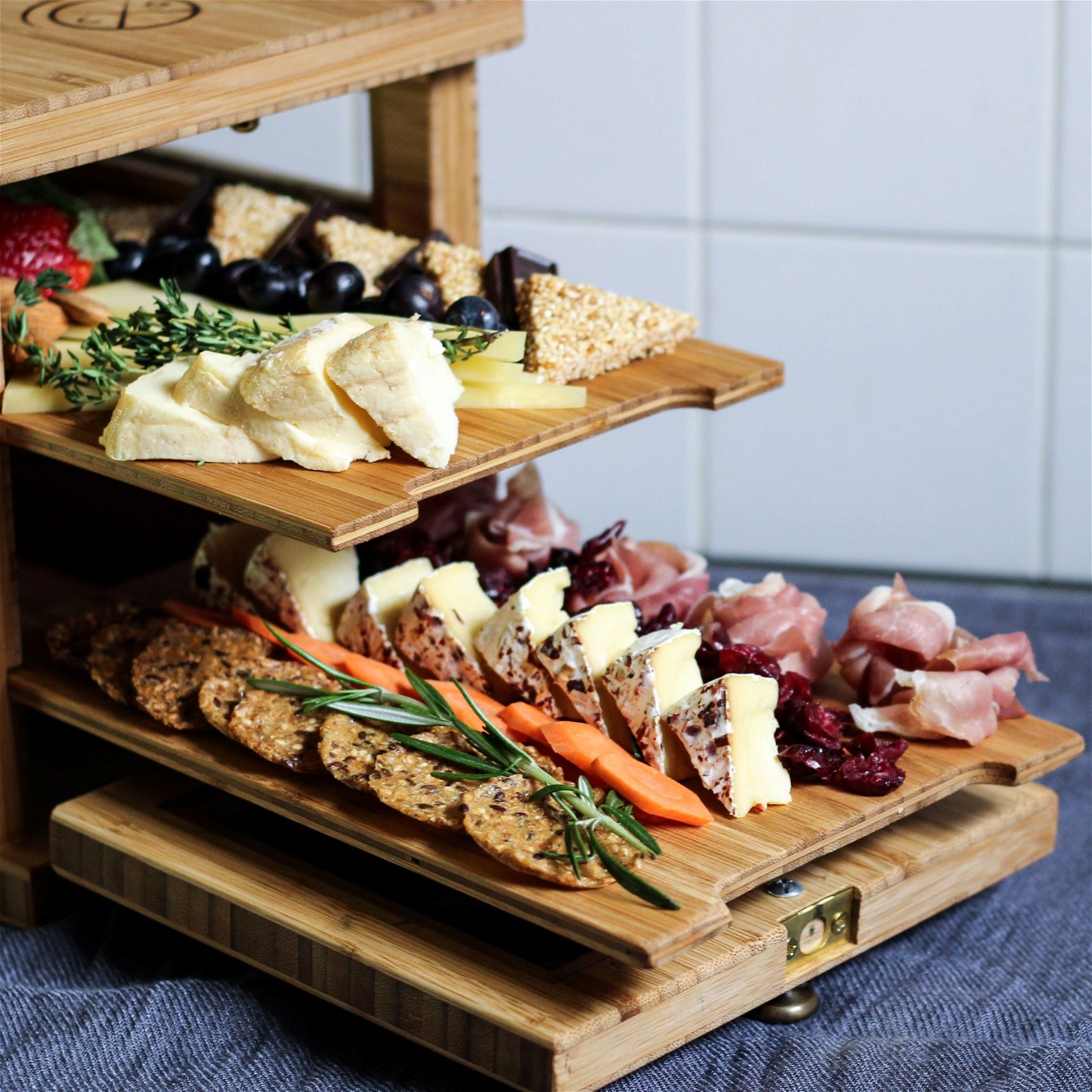 https://images.getrecipekit.com/20220426154909-two-20tiered-20cheese-20board.jpg?aspect_ratio=1:1&quality=90&