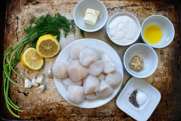 Image of Place the scallops, olive oil, butter, garlic, lemon juice, dill,...