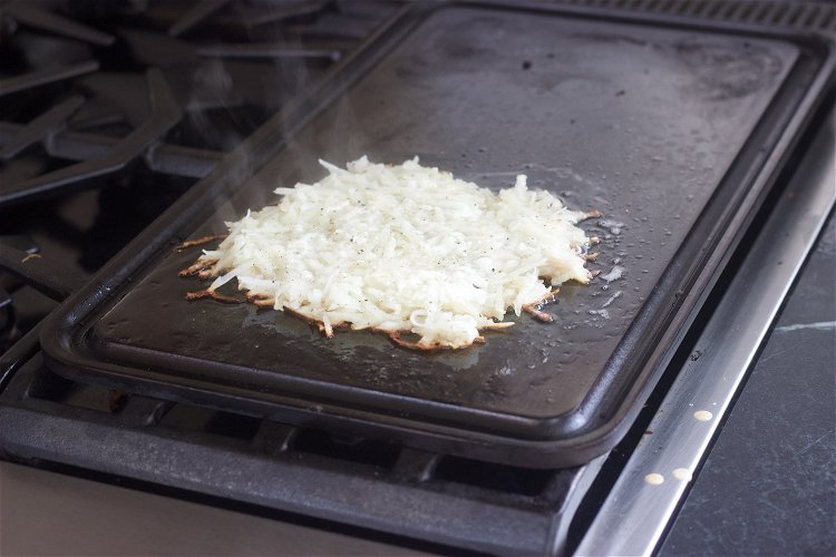 Image of Dump half of the butter onto griddle and place shredded...