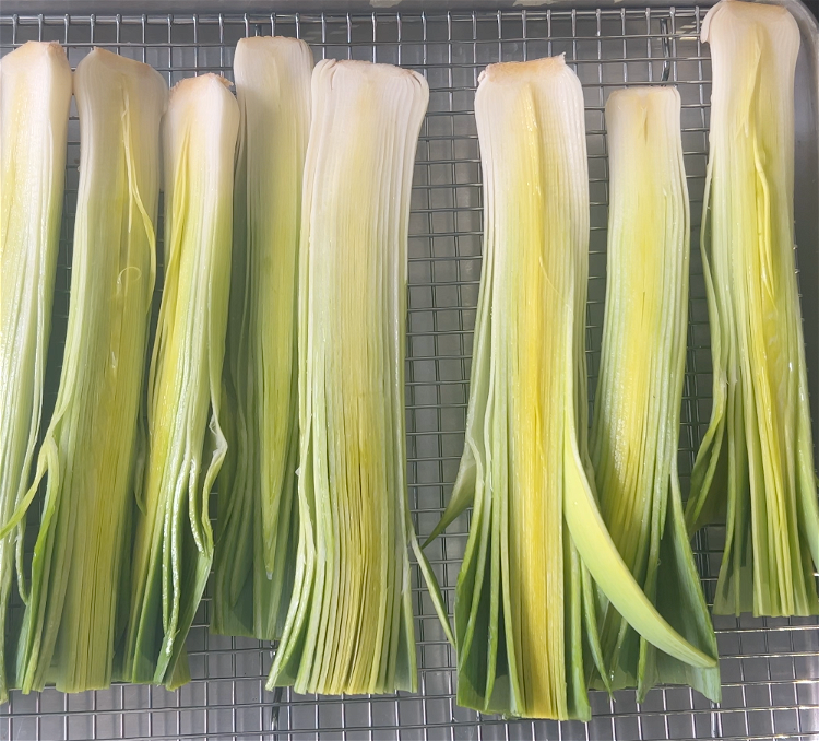 Image of Prepare a broiler safe tray with the clean leeks.