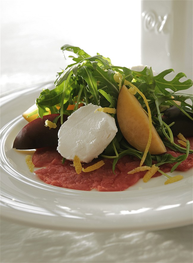 Image of Carpaccio with Arugula Manouri Cheese and Mastiha-Scented Olive Oil