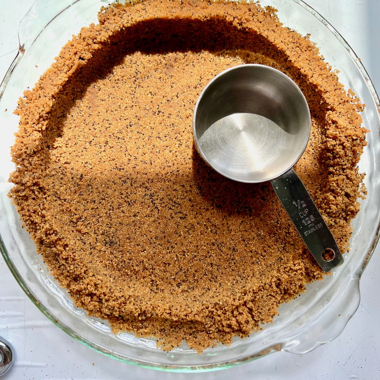 Image of Pour the
mixture into your pan dish. Press into the bottom and sides so that an even crust
forms — using a small measuring cup is definitely helpful.