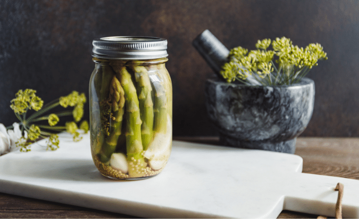 Image of Grab your warm jars and place a garlic clove, peppercorns,...