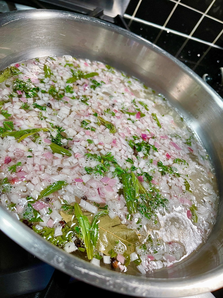 Image of Into a medium heated pan add wine, white wine vinegar, shallots, peppercorns, cloves, bay leaves, 80% of the tarragon