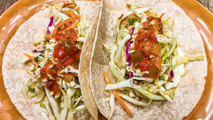 Image of Warm tortillas in microwave for five seconds. Add fish and top with slaw, mango salsa, and hot sauce. Enjoy!