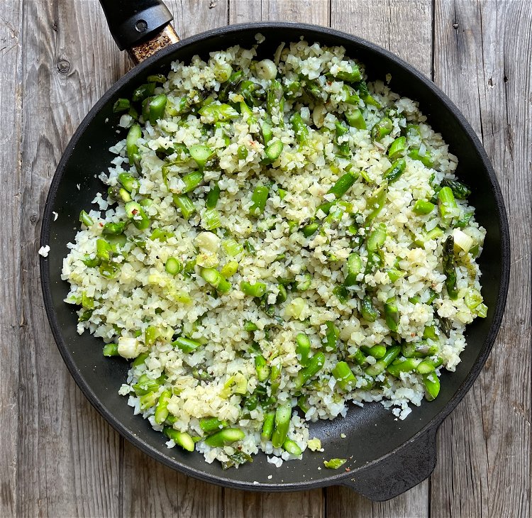 Image of Add the cauliflower rice and stir to combine. Cook for...